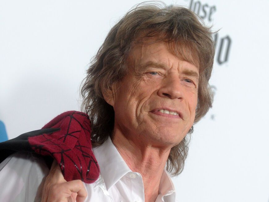 Mick Jagger grinst auf dem roten Teppich