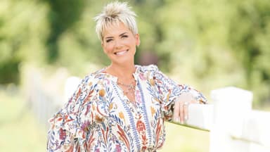 Inka Bause lächelt in der Natur