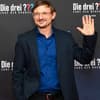 Florian Lukas lacht und winkt