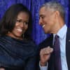 Michelle und  Barack Obama lachen sich an