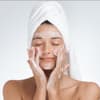 Frau reinigt ihr Gesicht, Schaum im Gesicht