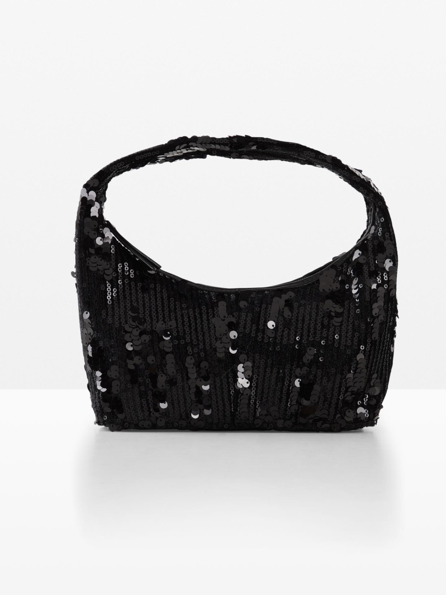 Die Handtasche mit Pailletten ist das i-Tüpfelchen jedes Outfits. Die Handtasche mit Pailletten ist das i-Tüpfelchen jedes Outfits.