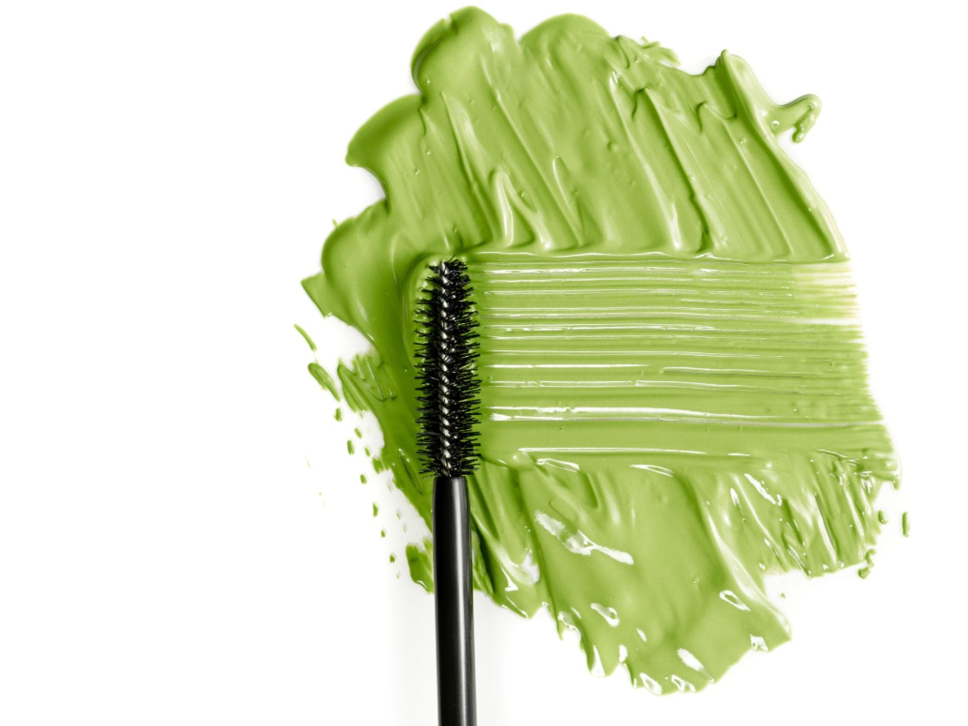 Grüne Mascara für braune und graue Augen Grüne Mascara Fleck auf weißen Hintegrund