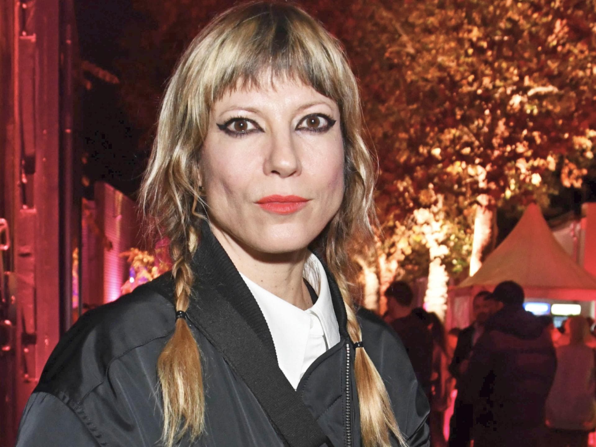 Mieze Katz mit geflochtenen Zöpfen und ernstem Blick