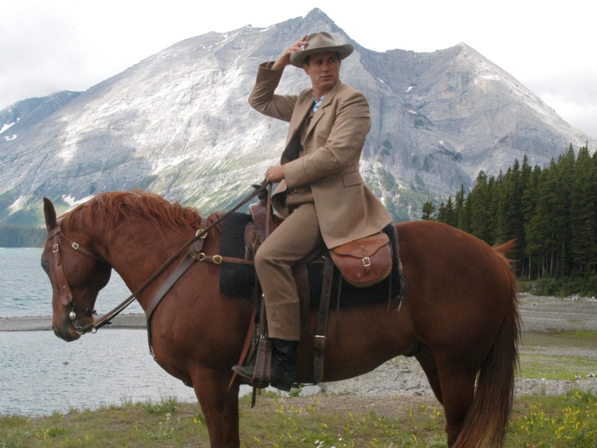 Ralf Bauer vor Bergen mit Pferd
