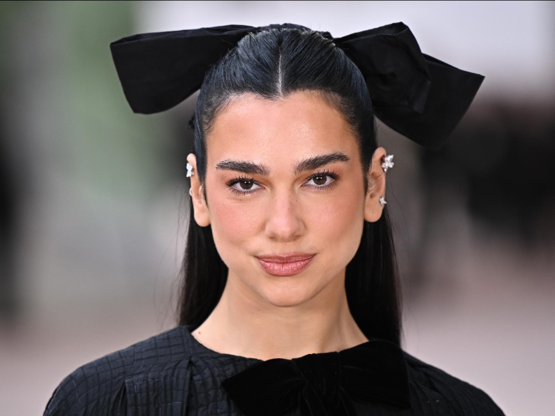 Dua Lipa Mascara Dua Lipa mit großer schwarzer Schleife im Haar