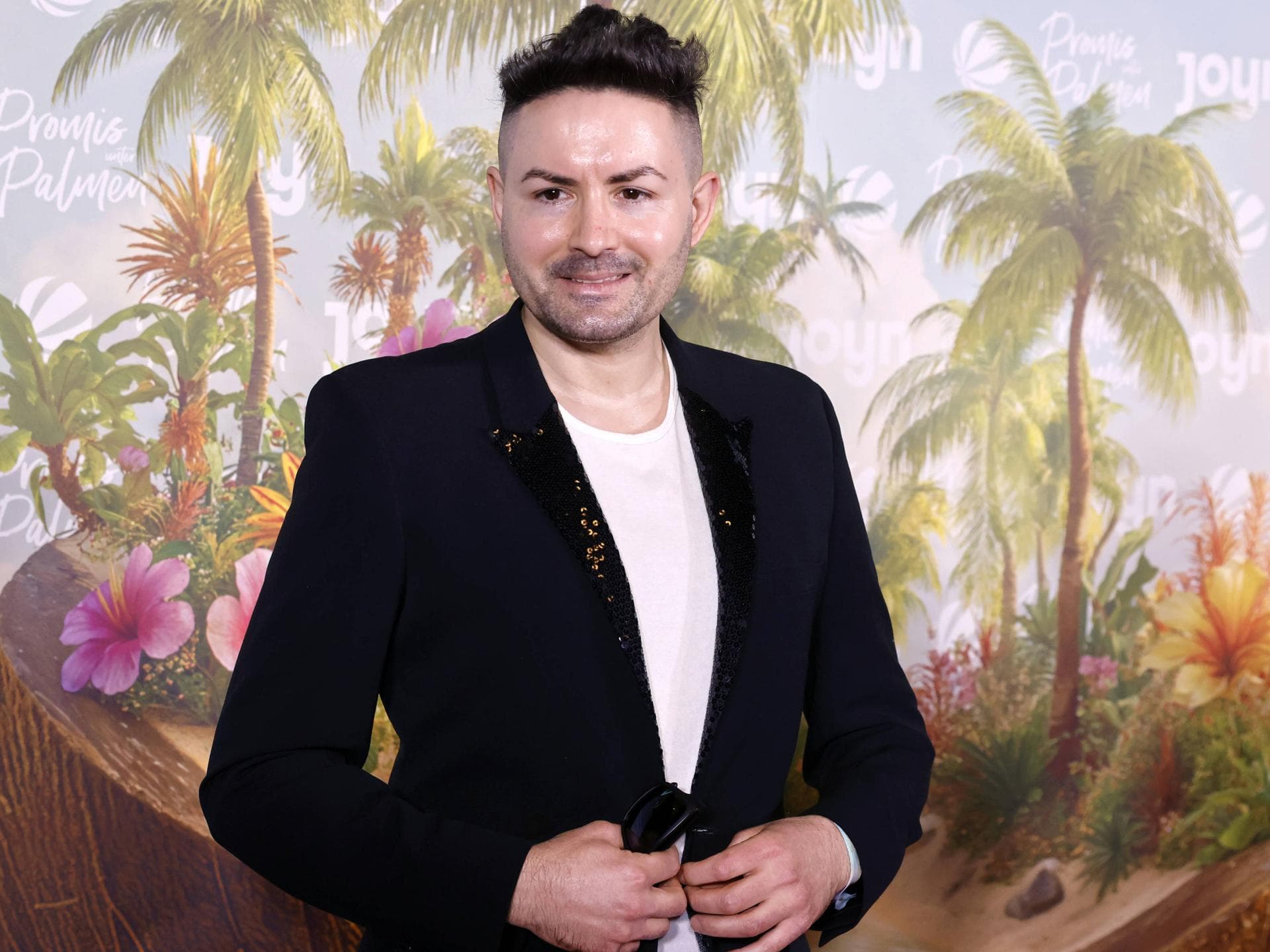 Menderes Bagci lächelt bei der Premiere von "Promis unter Palmen"