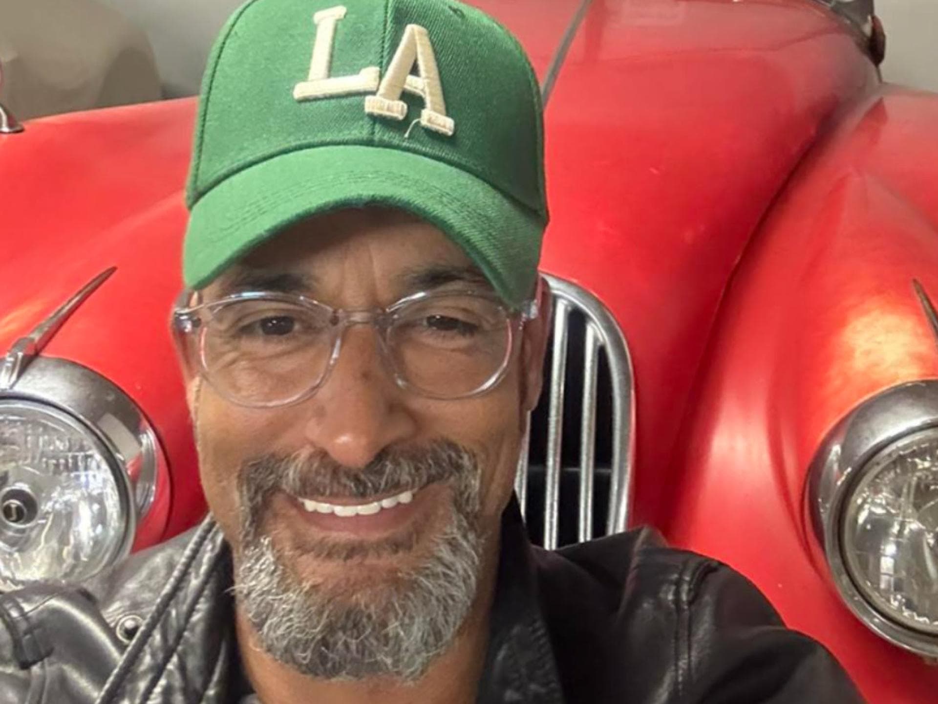 Mark Medlock vor rotem Oldtimer