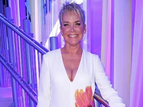 Inka Bause vor lila Kulisse