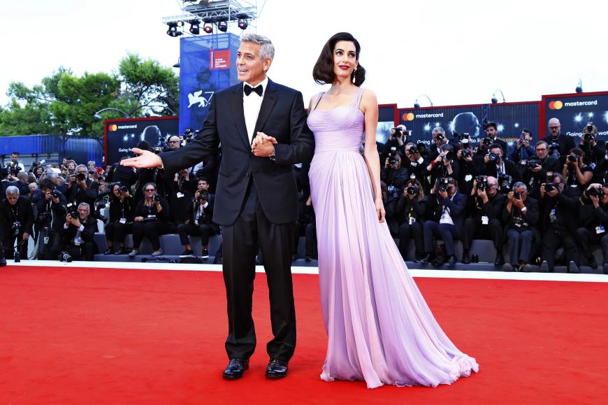 Sie waren die Hingucker des Tages: George Clooney und seine schöne Frau Amal – die erschien im fliederfarbenen Versace-Kleid und sorgte mit ihrem krassen After-Baby-Body für Schlagzeilen.