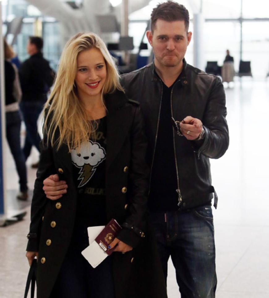 Sänger Michael Buble und seine Frau Luisana Lopilato sind ebenfalls gut gelaunt am Londoner Flughafen unterwegs