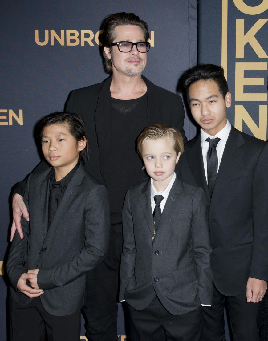 In der Öffentlichkeit zeigt sich Shiloh (Mitte) lieber im Anzug als im Kleid. Hier ist sie zusammen mit Vater Brad Pitt und ihren Brüdern Pax (links) und Maddox (rechts) zu sehen.