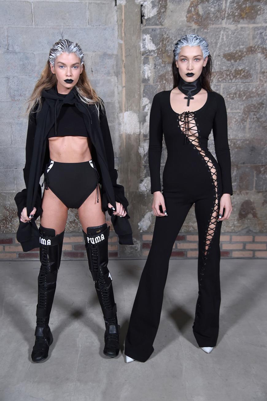 In knappen Crop-Tops und Boxerstiefeln schickte Riri die Models über den Catwalk. Bella Hadid (rechts) trug einen Jumpsuit mit Schnürung.