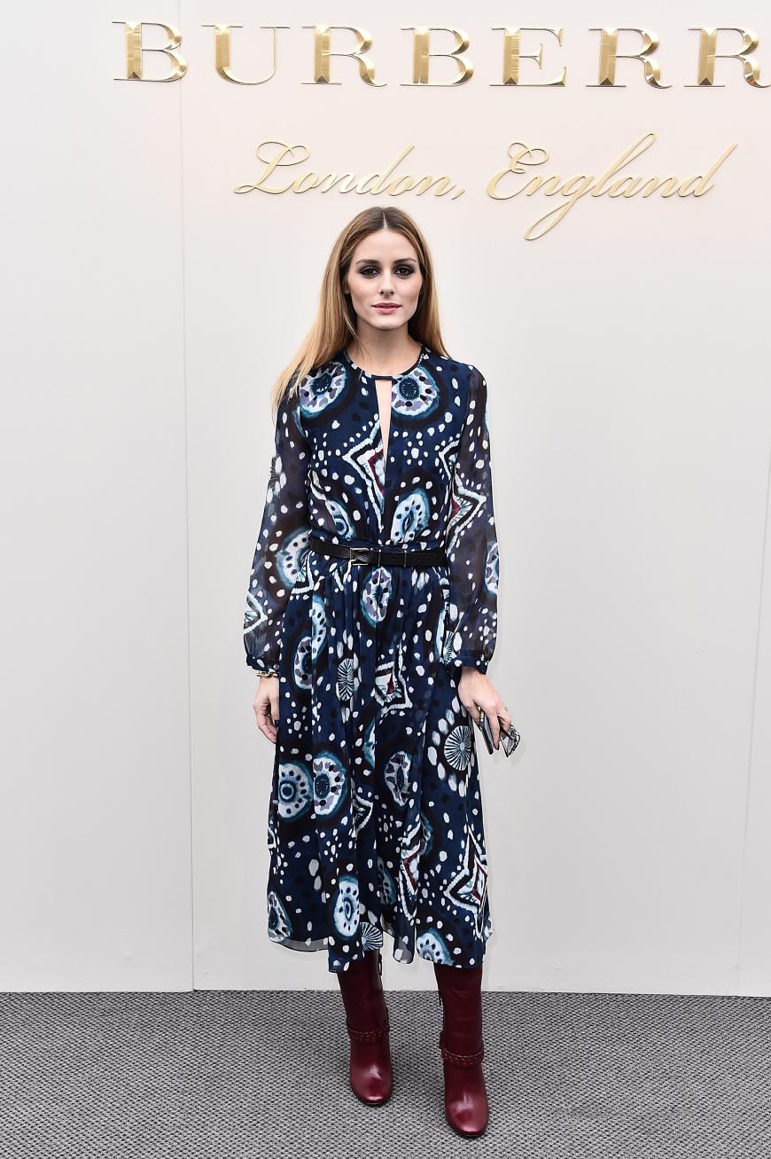 22. Februar 2016 - Burberry Prorsum Herbst/Winter 2016, New York Fashion Week: Olivia versprüht 70ies-Flair im midilangen Musterkleid zu bordeauxroten Stiefeln.