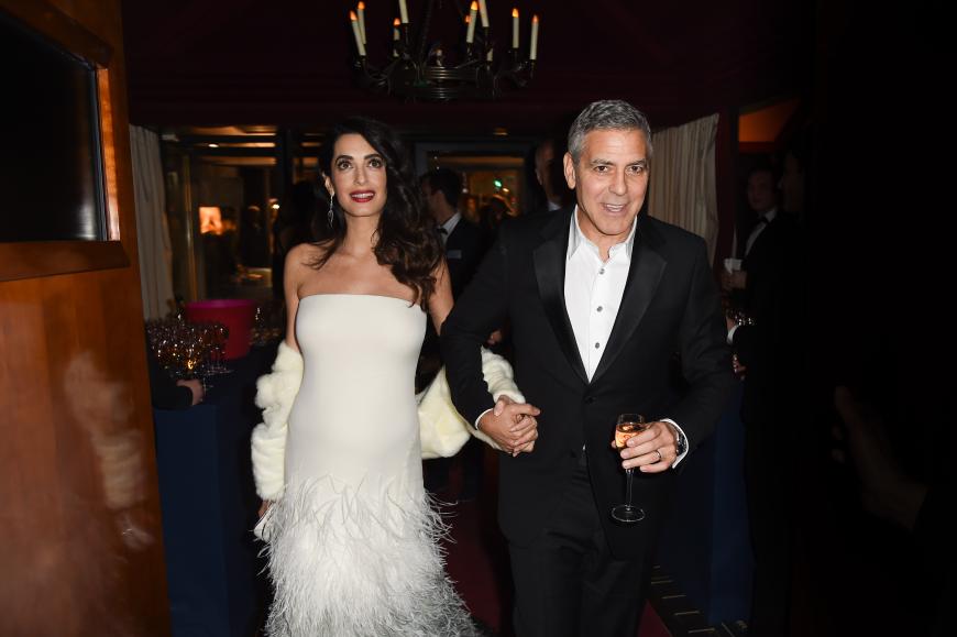 In einer weißen Robe mit Feder-Details, offener Hollywood-Mähne und klassischem Make-up bezauberte Amal bei ihrem Auftritt in Paris.