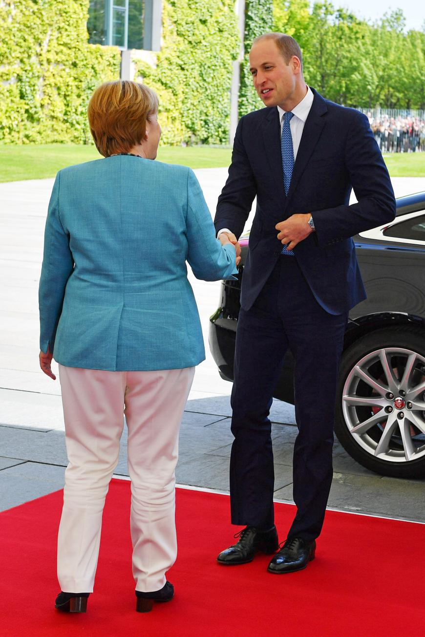 Prinz William trifft die deutsche Kanzlerin.