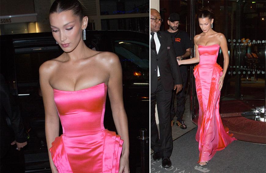 Model Bella Hadid verlässt ihr Hotel in Paris in einem knallpinken, schulterfreien Dress - mit Wespentaille und ziemlich betonter Oberweite. Hot! Auch wenn das Kleid nicht gerade bequem aussieht ...