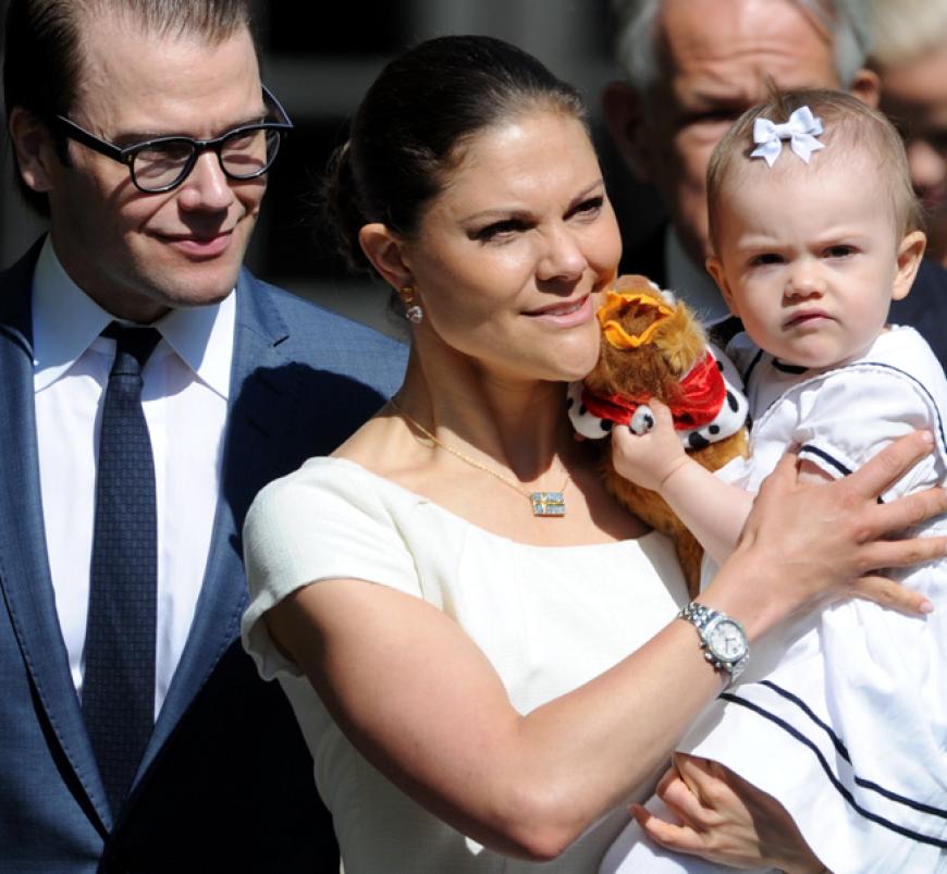 Die Kronprinzessin Victoria mit Prinz Daniel und Estelle im weißen Kleidchen und der obligatorischen Schleife im noch schütteren Haar