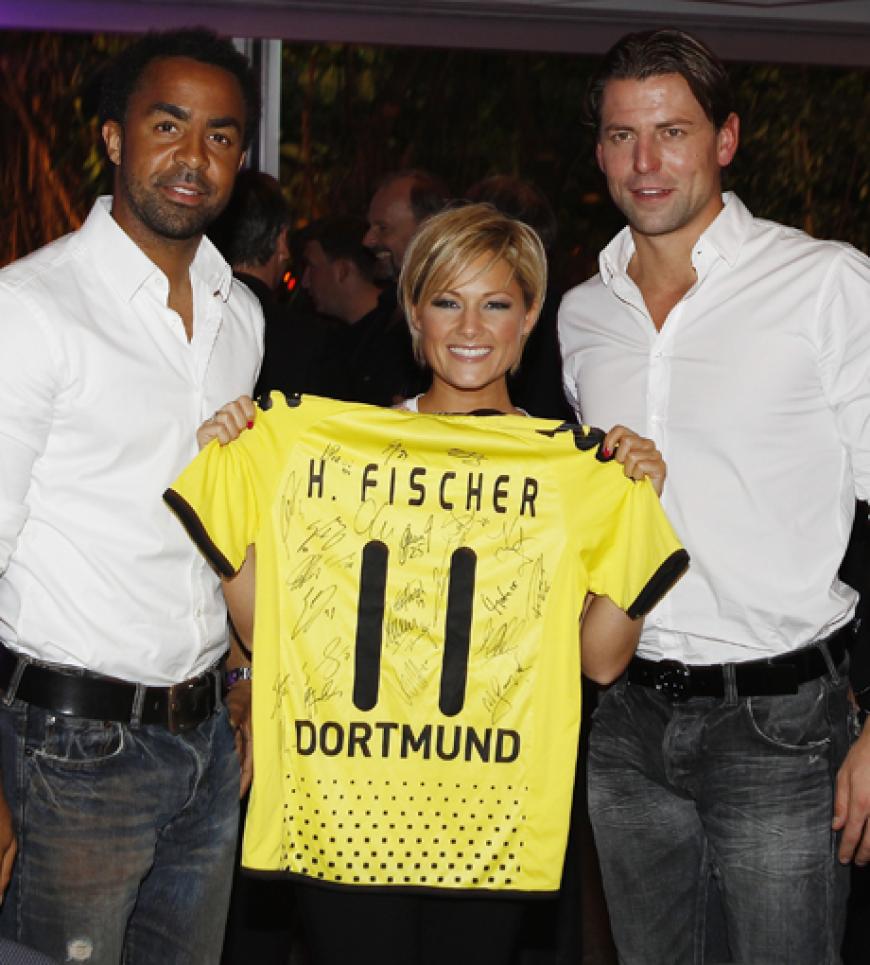 Patrick Owomoyela, Helene Fischer und Roman Weidenfeller im Oktober 2011