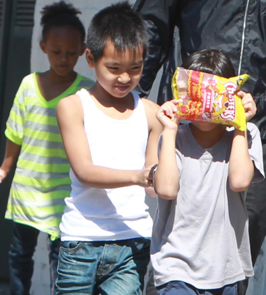 Maddox Chivan und sein Bruder Pax Thien albern herum und versuchen sich vor den Paparazzi zu verstecken