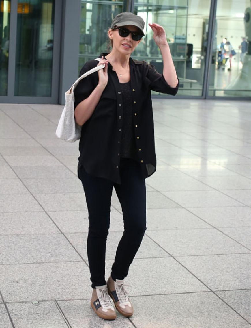 Ganz in Schwarz mit Kappe und dunkler Sonnenbrille versucht diese Sängerin unerkannt zu bleiben - doch uns entgeht nichts. Auch keine Kylie Minogue am Airport in Heathrow in London