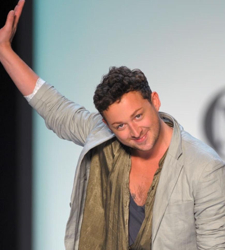 Der junge Münchner Designer Marcel Ostertag winkt zum Abschluss seiner Show dem Publikum zu