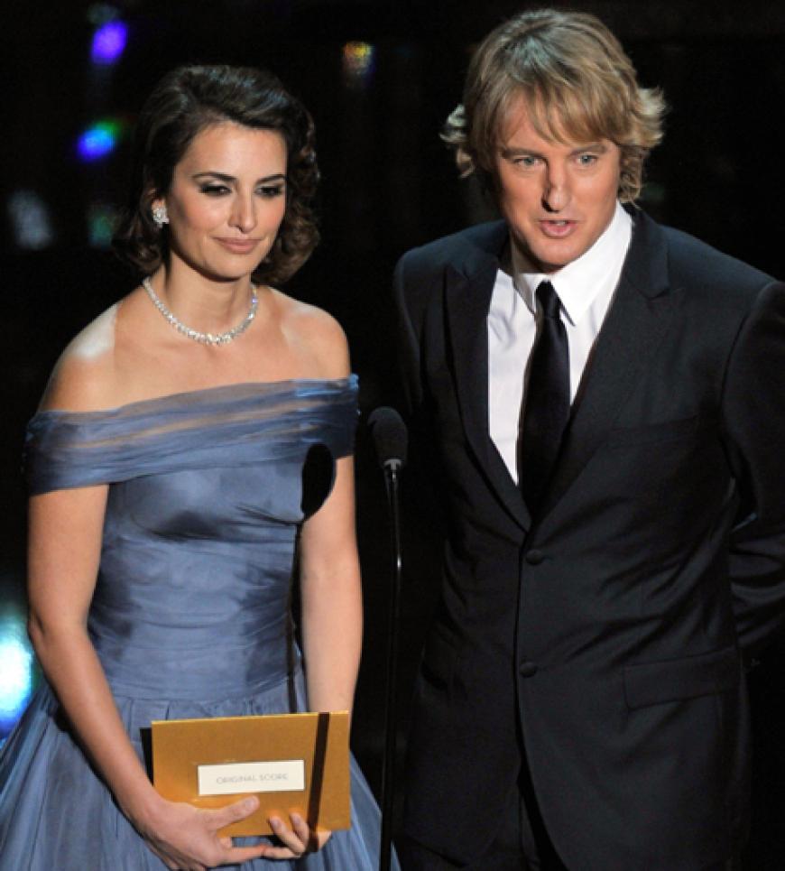 Penelope Cruz und Owen Wilson auf der Bühne. Sie präsentieren den Oscar für die beste Musik. Und der geht an Ludovic Bource für