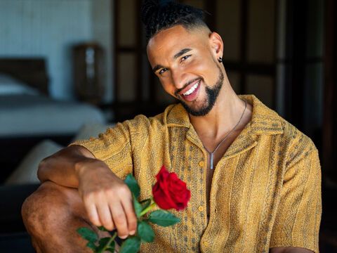 Bachelor David Jackson lächelt und hält eine Rose in der Hand.