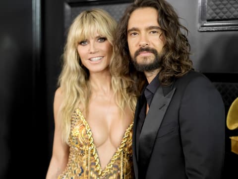 Heidi Klum und Tom Kaulitz stehen nebeneinander bei den Grammys und lächeln in die Kamera.