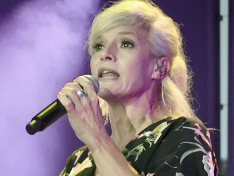 Ina Müller singt ins Mikrofon auf der Bühne