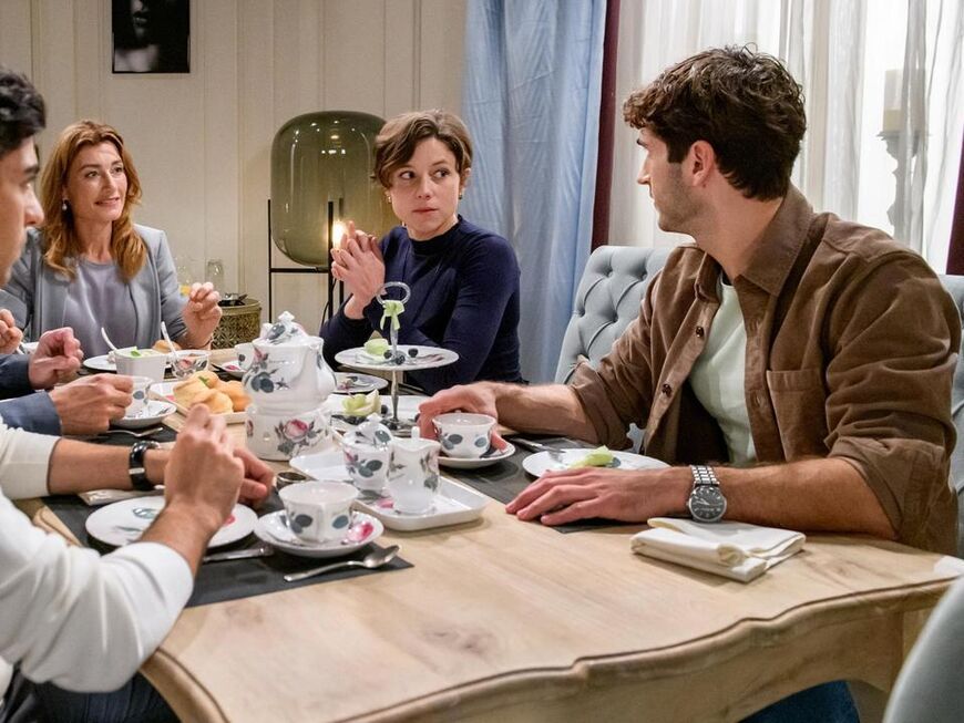 Sturm der Liebe Eleni und Leander sitzen mit Alexandra, Christoph und Noah an einem gedeckten Tisch