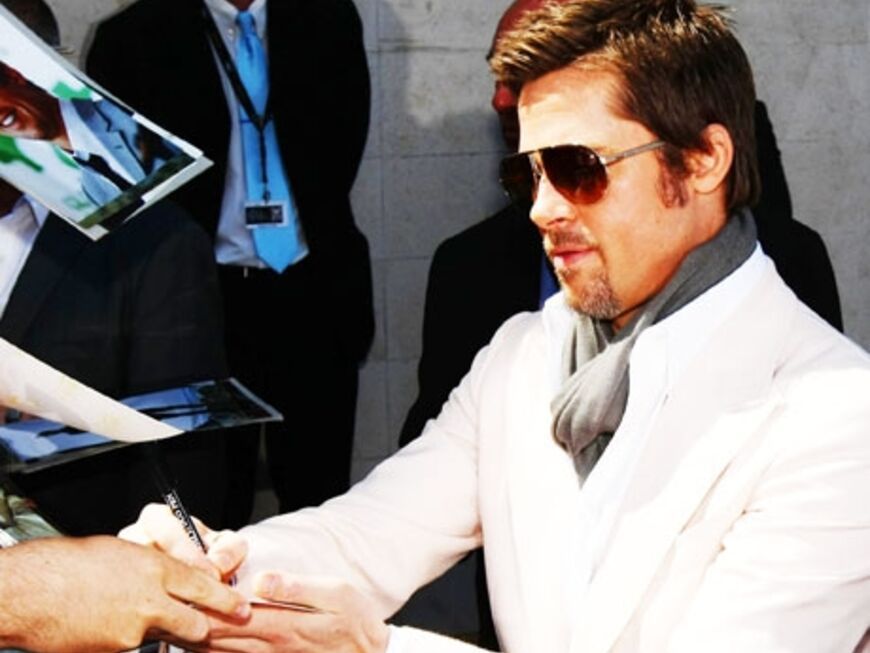 Brad Pitt schreibt Autogramme