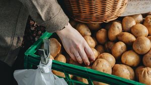 Frau kauft Kartoffeln für Diät ein 